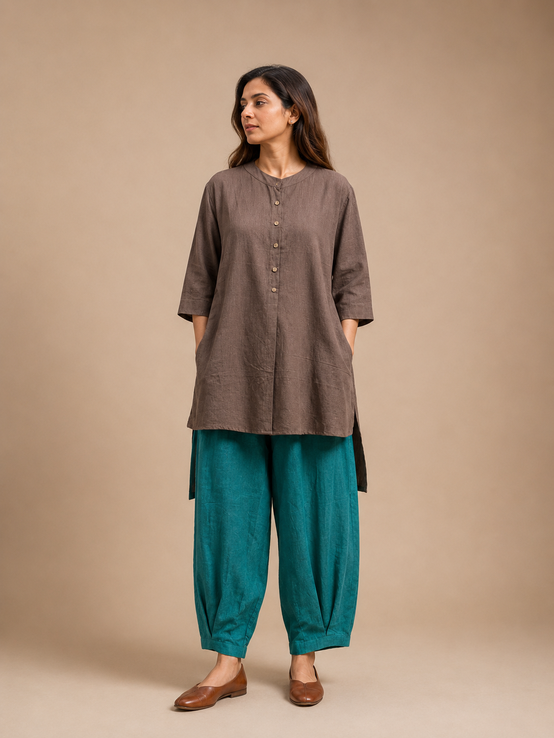 Pleated pants paired with a half placket flared tunic, featuring a relaxed silhouette and contemporary artisanal detailing by Bohe by NAM.
