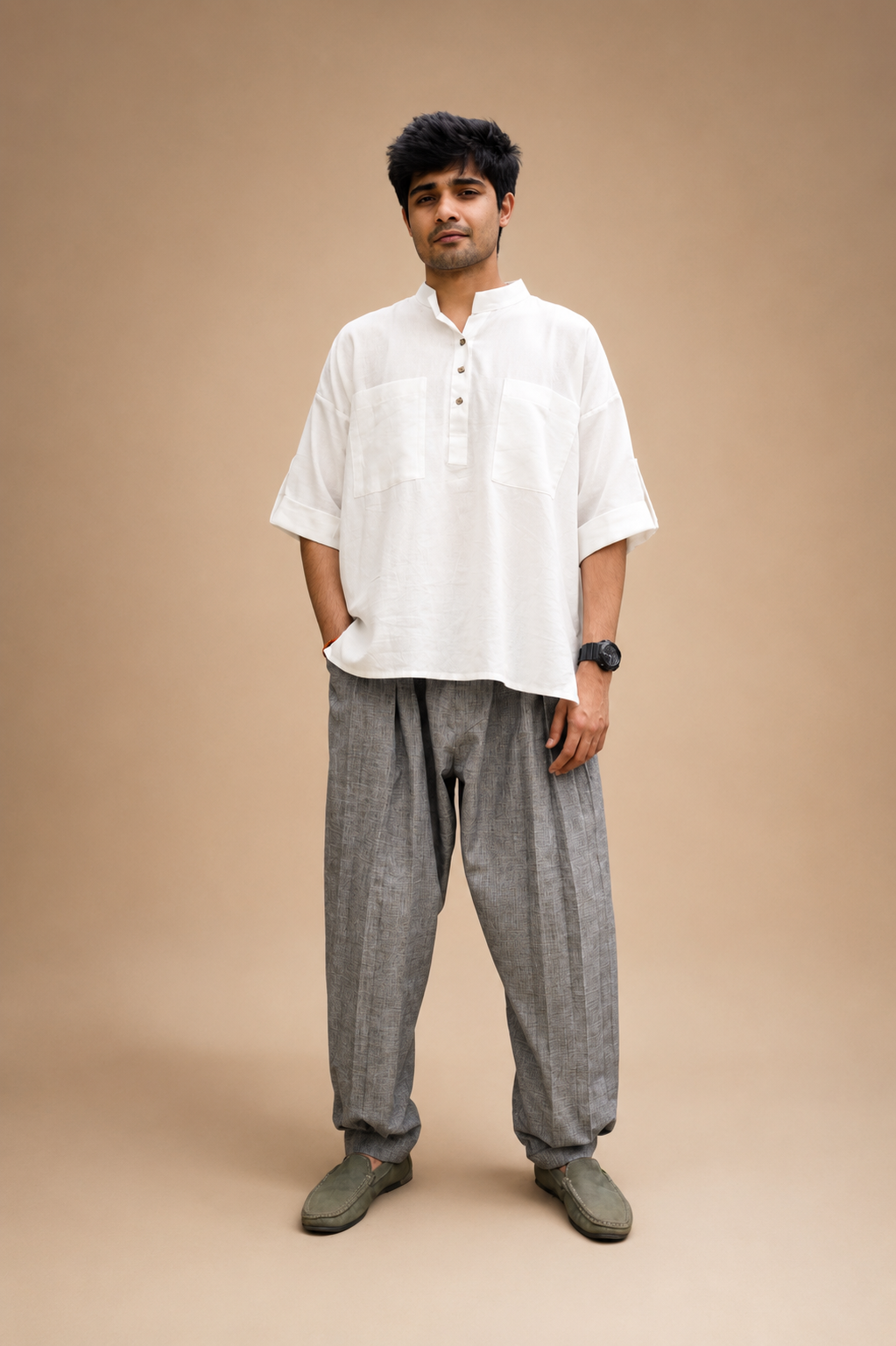Pleated pants paired with a high-low kurta featuring patch pockets and a relaxed contemporary silhouette by Bohe by NAM.