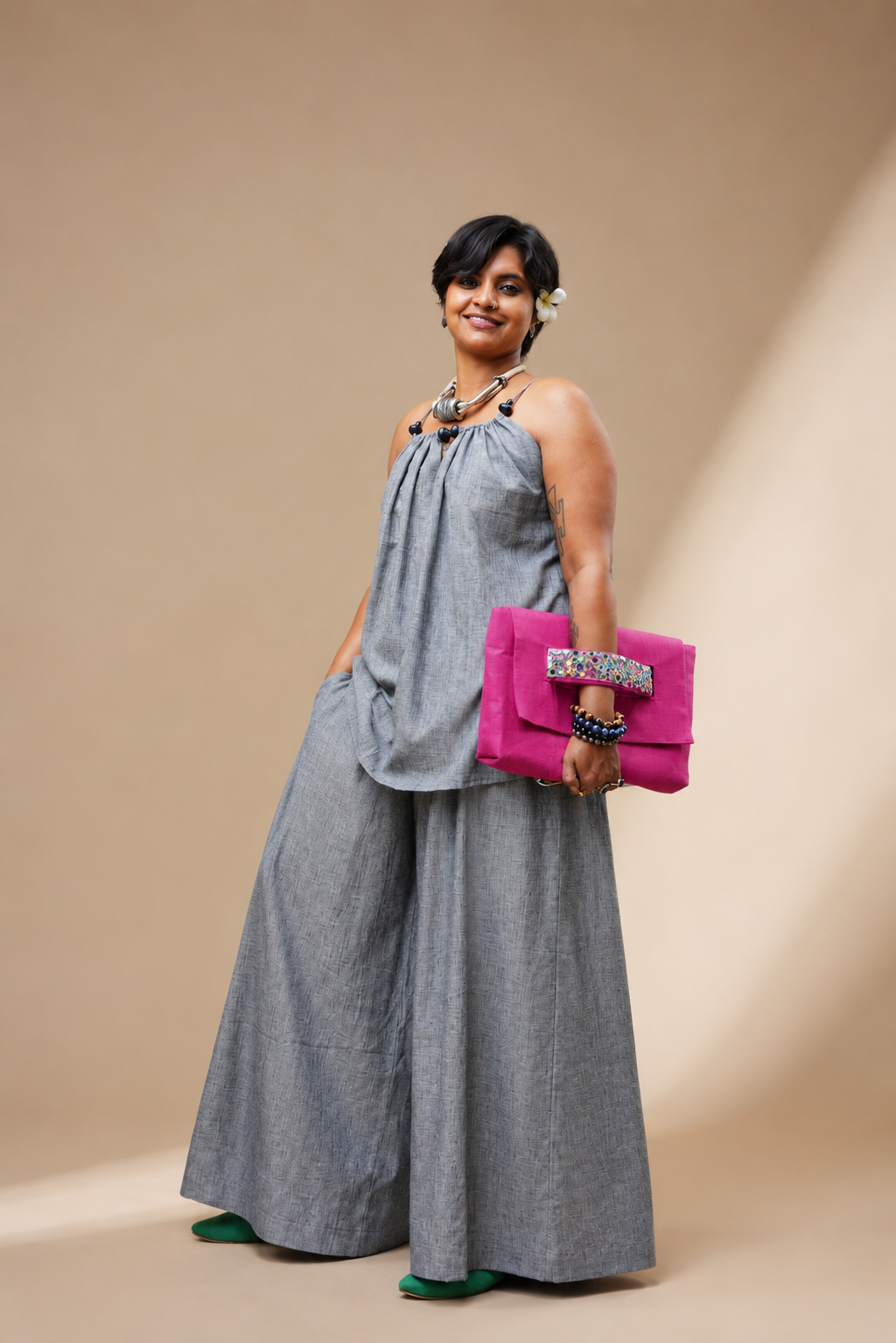 Spaghetti strap tunic with wooden bead detailing paired with wide leg pants, featuring abstract design elements and an effortless contemporary silhouette by Bohe by NAM.
