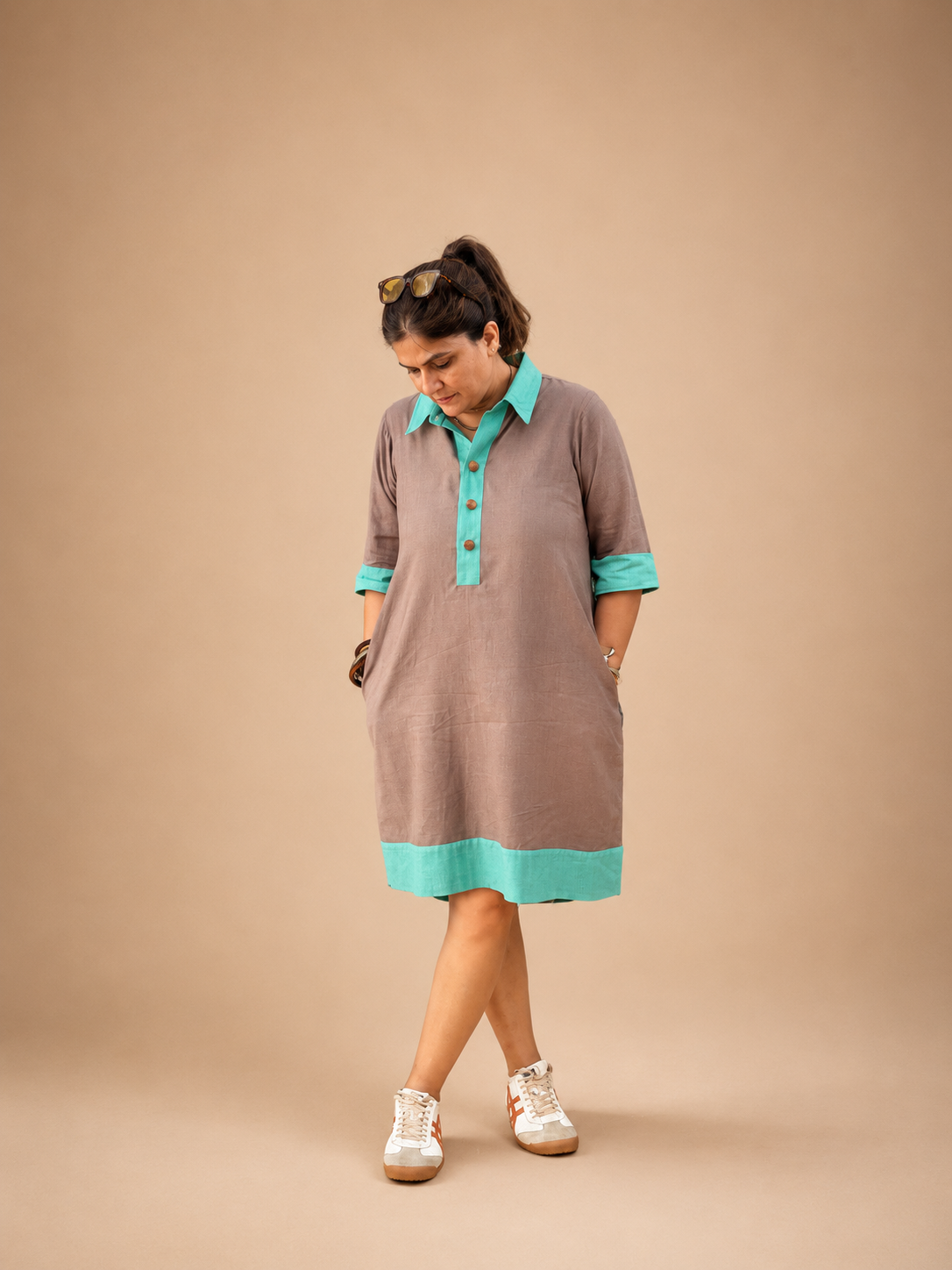 wearing a half placket khadi colour block dress crafted in breathable handwoven khadi, featuring a relaxed silhouette and contemporary colour block detailing.